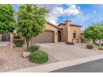Lovely home showcases mature trees, desert landscaping, paver driveway, and attached two-car garage at 10713 N 124Th Pl, Scottsdale, AZ 85259