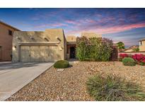 Charming single-story home featuring a xeriscaped front yard, an attached garage and beautiful desert landscaping at 15656 W Devonshire Ave, Goodyear, AZ 85395