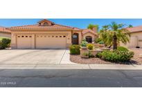 Charming single-story home featuring a three-car garage and lush landscaping, perfect for curb appeal at 16151 W Fairmount Ave, Goodyear, AZ 85395