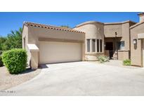 Charming single-story home featuring a two-car garage, tile roof, and well-maintained landscaping at 19475 N Grayhawk Dr # 1046, Scottsdale, AZ 85255