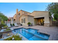 Inviting backyard with a sparkling pool and a cozy patio area, perfect for outdoor entertaining at 19475 N Grayhawk Dr # 1046, Scottsdale, AZ 85255