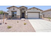 Charming single-Gathering home featuring stone accents, neutral stucco, a two-car garage, and low-maintenance landscaping at 20263 W Catalina Dr, Buckeye, AZ 85396
