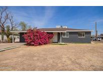 Charming single-story home featuring a dark gray brick exterior and a well-manicured front yard at 3222 W Marshall Ave, Phoenix, AZ 85017