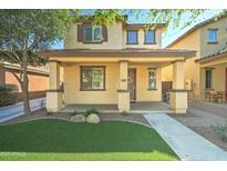 Charming two-story home with a covered porch and landscaped front yard featuring synthetic grass at 3455 E Oakland St, Gilbert, AZ 85295