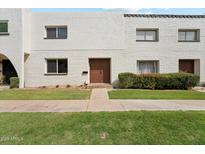 Attractive exterior with a well-manicured lawn, sidewalk, and charming front door at 4323 N Miller Rd, Scottsdale, AZ 85251