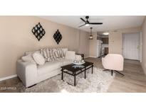 Inviting living room with comfortable seating, modern decor, and wood laminate flooring at 5518 E Lindstrom Ln # 3012, Mesa, AZ 85215