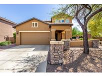 Charming two-story home featuring a two-car garage, inviting front porch, and low maintenance desert landscaping at 7359 W Kings Ave, Peoria, AZ 85382