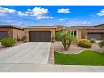 Charming single-story home featuring a well-manicured yard, a two-car garage and neutral color palette at 77 E Atole Ct, Queen Creek, AZ 85140