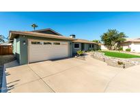 A wide driveway leads to an attached garage in this well-maintained home with desert landscaping at 810 W Villa Maria Dr, Phoenix, AZ 85023