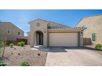 Charming single-story home featuring a neutral color palette, desert landscaping, and a welcoming arched entryway at 13511 W Cassia Trl, Peoria, AZ 85383