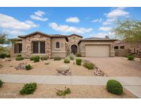 Charming home featuring a stone facade, a paver driveway, and desert landscaping in a well-maintained front yard at 1608 W Calle De Pompas --, Phoenix, AZ 85085