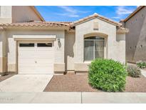 Charming home featuring a one-car garage, arched window, and manicured landscaping at 2600 E Springfield Pl # 58, Chandler, AZ 85286