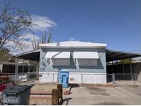 Single story home featuring desert landscaping, awnings, and concrete driveway at 2630 E Beverly Ln, Phoenix, AZ 85032