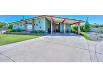 Charming single-story home with a spacious driveway, manicured lawn, and covered parking at 3328 S Stanley Pl, Tempe, AZ 85282