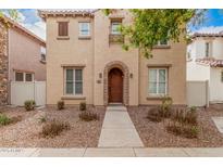 Charming two-story home with a warm beige exterior, arched entry, and well-maintained front yard at 3591 S Ranger Trl, Gilbert, AZ 85297