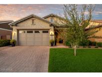 Charming home featuring a well-manicured lawn and a brick driveway leading to an attached two-car garage at 3918 E Arabian Dr, Gilbert, AZ 85296