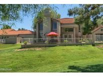 Inviting backyard with lush green grass, privacy fence, and outdoor seating area at 4020 E Laurel Ln, Phoenix, AZ 85028