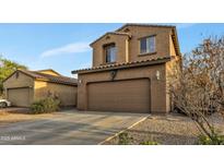 Two-story home featuring a two car garage, neutral color scheme and drought resistant landscaping at 41369 W Parkhill Dr, Maricopa, AZ 85138