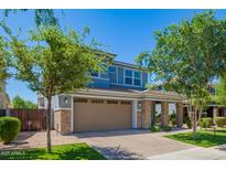 Charming two-story home with a brick facade, a two-car garage, and lush landscaping at 4253 E Palo Verde St, Gilbert, AZ 85296