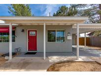 Inviting front exterior featuring a red door, covered entry, and well-maintained landscaping at 4440 E Campbell Ave, Phoenix, AZ 85018