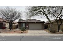 Charming single-story home featuring a neutral color scheme, well-kept landscaping, and a two-car garage at 46037 W Starlight Dr, Maricopa, AZ 85139