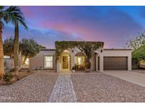 Inviting single-story home with arched entryway covered in lush greenery and a well-maintained landscape at 863 W Kiva Ave, Mesa, AZ 85210