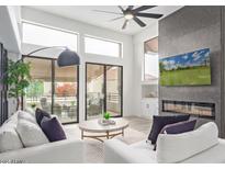 Bright living room with modern fireplace, large windows, and access to outdoor seating at 8989 N Gainey Center Dr # 231, Scottsdale, AZ 85258
