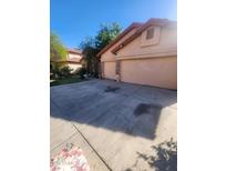 This home features a spacious two car garage and large driveway at 11233 W Olive Dr, Avondale, AZ 85392