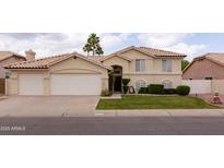 Charming two-story home featuring a well-manicured lawn and a spacious two-car garage at 1150 E Tyson St, Chandler, AZ 85225