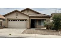 Charming single-story home with a well-maintained front yard, two-car garage, and desert landscaping at 12371 W Hadley St, Avondale, AZ 85323