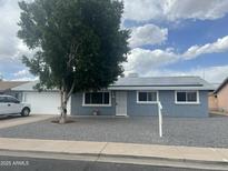 Charming single-story home featuring solar panels, gravel landscaping, and a mature shade tree at 1740 W Crescent Ave, Mesa, AZ 85202