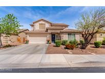 Charming two-story home featuring a well-manicured front yard and a spacious two-car garage at 17538 W Marshall Ln, Surprise, AZ 85388