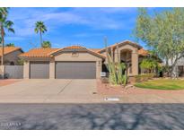 Charming single-Gathering home featuring a tile roof, desert landscaping, and a two-car garage at 18014 N 53Rd Pl, Scottsdale, AZ 85254