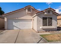 Charming single-story home with a two-car garage, red tile roof, and well-maintained landscaping at 1836 N Stapley Dr # 4, Mesa, AZ 85203