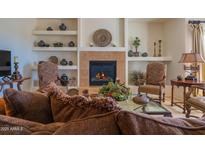 Inviting living room with fireplace, elegant decor, and comfortable seating arrangements at 19700 N 76Th St # 2001, Scottsdale, AZ 85255