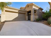 Charming single-story home featuring an attached two-car garage, neutral stucco, and a concrete driveway at 4031 E Barwick Dr, Cave Creek, AZ 85331