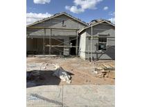 Unfinished exterior elevation featuring scaffolding and dirt lot in front of a gray stucco house with garage at 4196 E Kolin Ln, San Tan Valley, AZ 85143