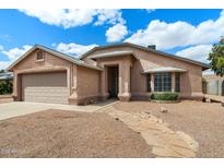 Charming single-story home featuring stucco siding, a stone walkway, and a well-manicured front yard at 450 E Duke Dr, Casa Grande, AZ 85122