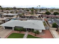 Aerial view of a single-Gathering home with well-maintained front yard and mature trees at 6207 W Orange Dr, Glendale, AZ 85301