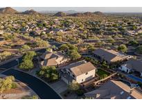 Stunning aerial view of a suburban neighborhood with desert landscaping, mountains, and beautiful homes at 9443 E Mallory St, Mesa, AZ 85207