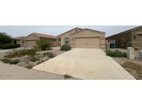 Charming single-story home featuring a low-maintenance desert landscape and a two-car garage at 13142 E Aster Ln, Florence, AZ 85132