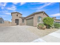 Charming single-story home features desert landscaping, paver driveway, and a two-car garage at 1900 N 140Th Dr, Goodyear, AZ 85395