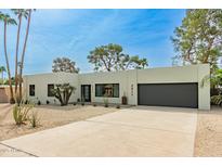 Contemporary home featuring desert landscaping, modern architecture, and a spacious driveway at 2517 E Sahuaro Dr, Phoenix, AZ 85028