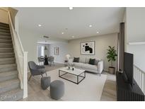 Bright living room features modern furnishings, neutral tones, and an open concept layout to the dining area at 815 E Rose Ln # 105, Phoenix, AZ 85014
