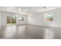 Bright, open living room featuring hardwood floors and a sliding glass door at 947 E Wiley Way, Casa Grande, AZ 85122