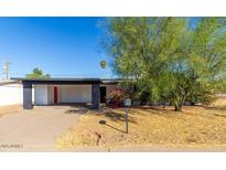 Charming single-story home with an open carport and mature landscaping, offering shade and curb appeal at 1038 E Northern Ave, Phoenix, AZ 85020