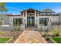 Inviting front elevation with brick pathway, private courtyard, desert landscaping and beamed entry at 12633 N 81St St, Scottsdale, AZ 85260