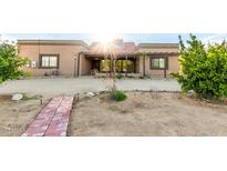 A home with a brick walkway and desert landscaping, offering a serene and welcoming entrance at 20420 N 22Nd St, Phoenix, AZ 85024