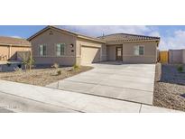 Charming single-story home with a well-maintained front yard and a two car garage at 4051 N Ghost Hollow Way, Casa Grande, AZ 85122