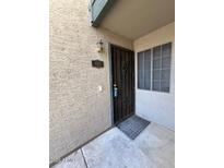 Inviting front door with secure iron gate and address number visible, offering security and curb appeal at 533 W Guadalupe Rd # 1110, Mesa, AZ 85210